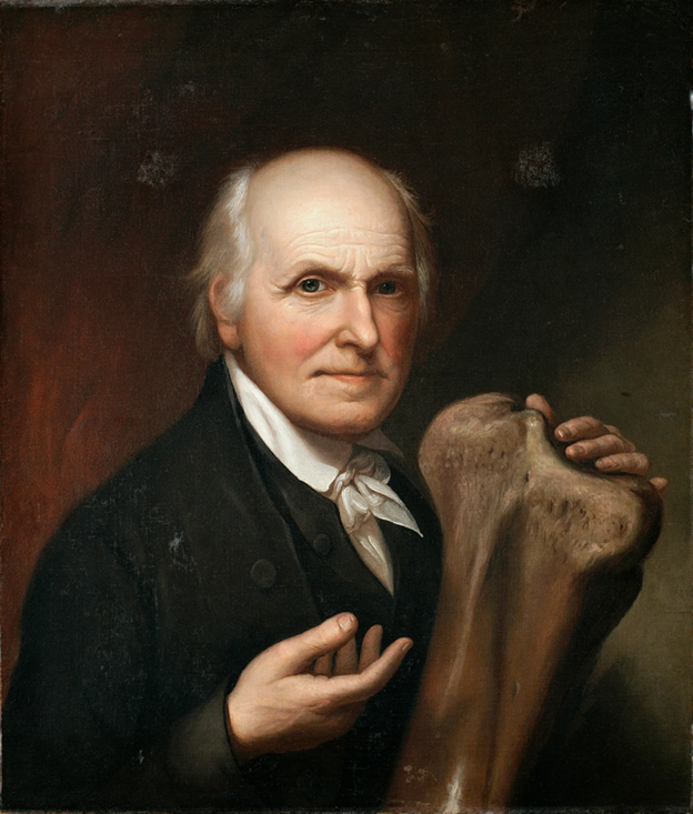 Portrait of a man holding a fossil bone.