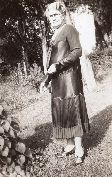 Febb Burn at her Niota farm A woman with glasses stands in a garden