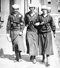 Black and white photgraph of three women walking through the navy yard in their &quot;Yeomanette&quot; uniforms