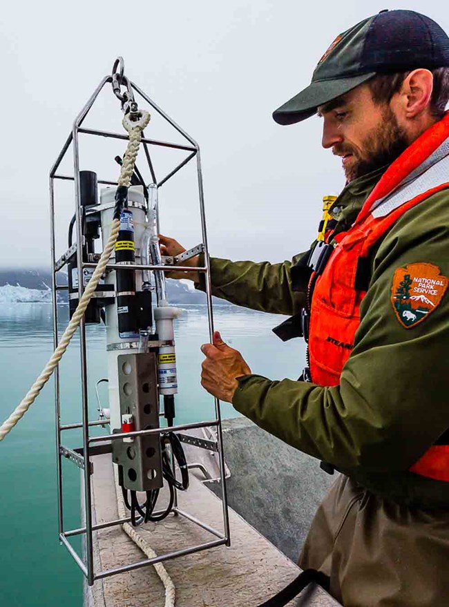 A scientist readies equipment.