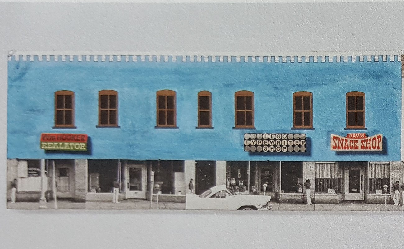 Fig6_Scale model for the Store Restoration Project Drawing of store front painted pastel blue with brown window trim.