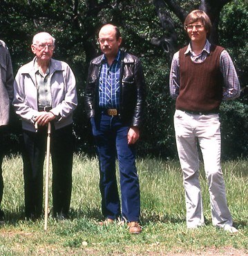 Figure 3 flfo a group of three men standing together in a field