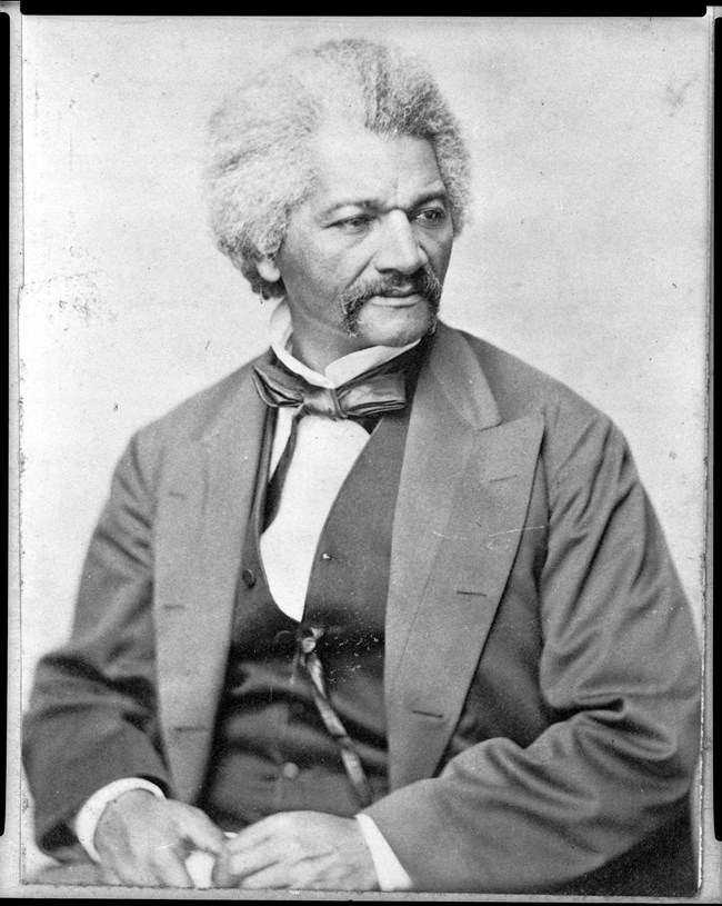 Black and white portrait of Frederick Douglass from the chest up facing right