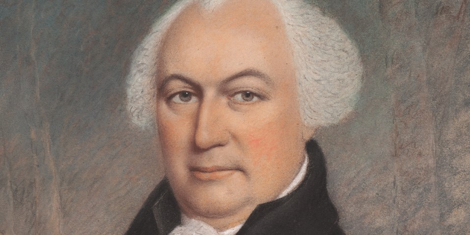 Pastel portrait close up of Morris in a brown coat.
