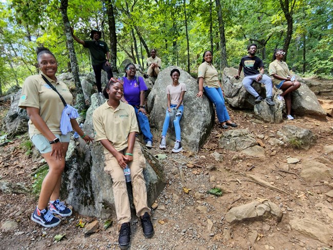Greening Youth Foundation interns resting on rocks during a hike in Kennesaw Mountain National Battlefield Park
