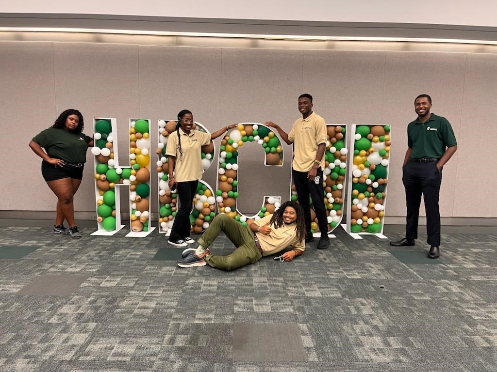 Greening Youth Foundation interns pose around large letters that spell out "HBCUI" at its annual conference
