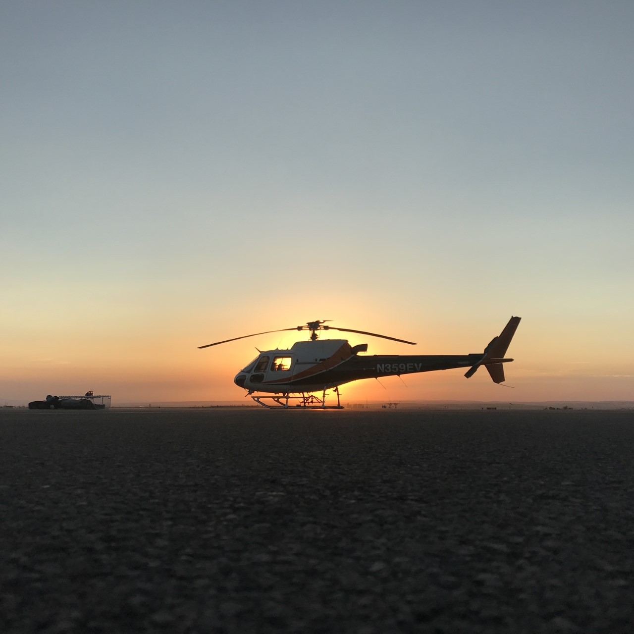 Helicopter with setting sun in background (Keith Mitchell, NPS)