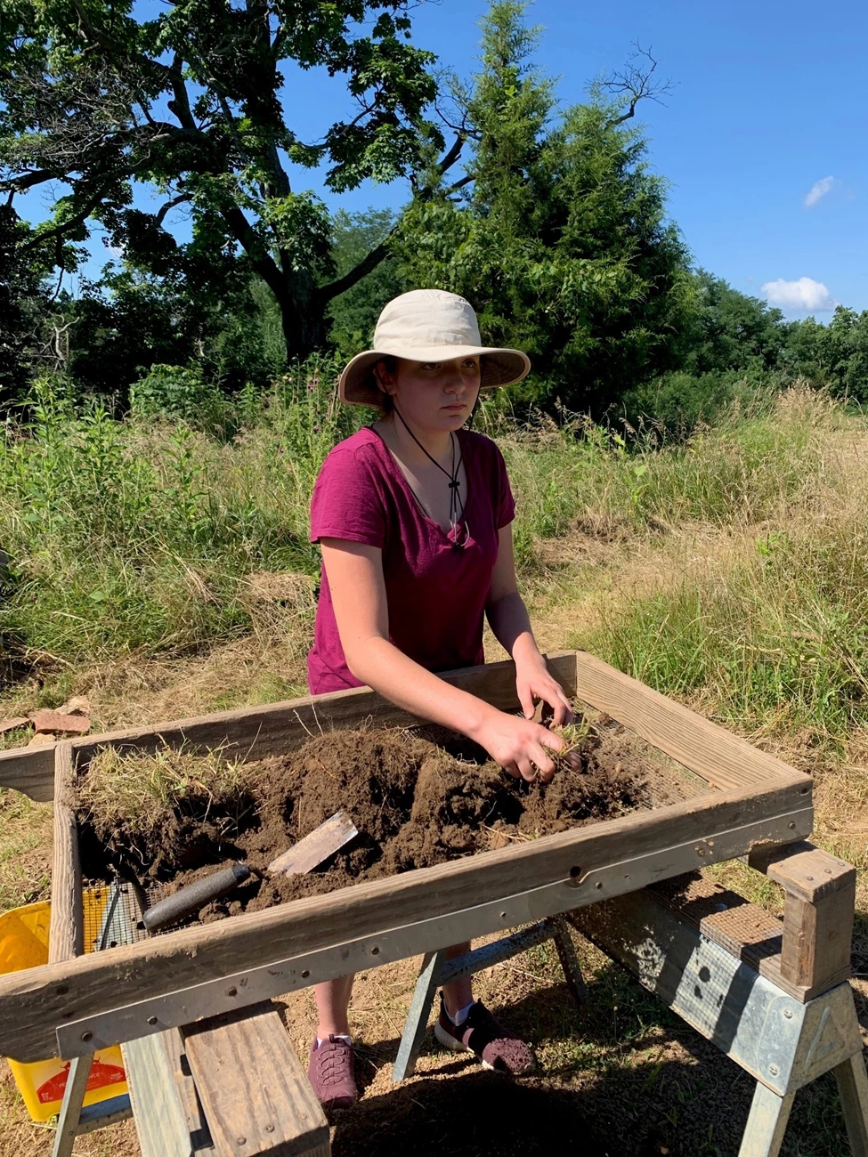 IG Story Photo 4 - Archaeology Oldham County Takeover the Network A high school student pushes dirt through a sieve as part of an archaeological study.