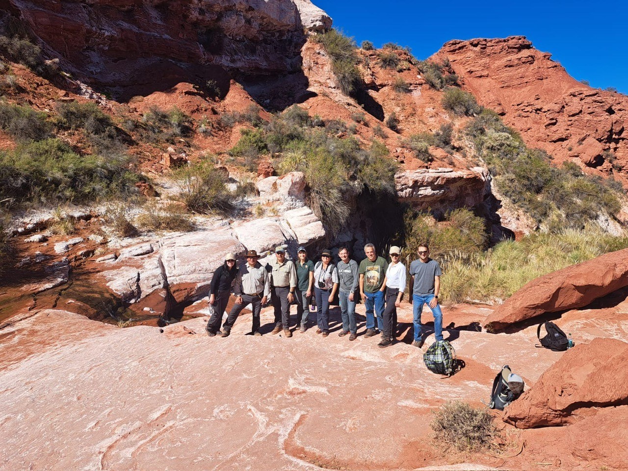 Photo of a group of people in a desert canyon.