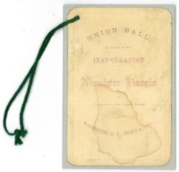 Faded ticket with green string tied through a punch hole in the upper left corner.