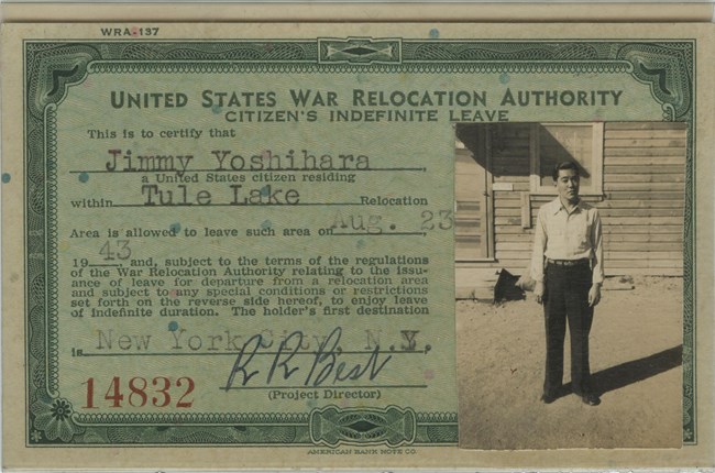 Pale green card with text printed in darker green like a dollar bill. The card describes the terms of indefinite leave and is signed by R.R. Best. Photo of Japanese American young man enclosed at right.