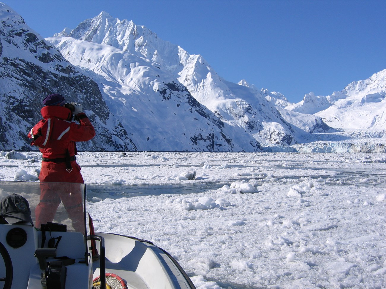 woman looking at iceberg