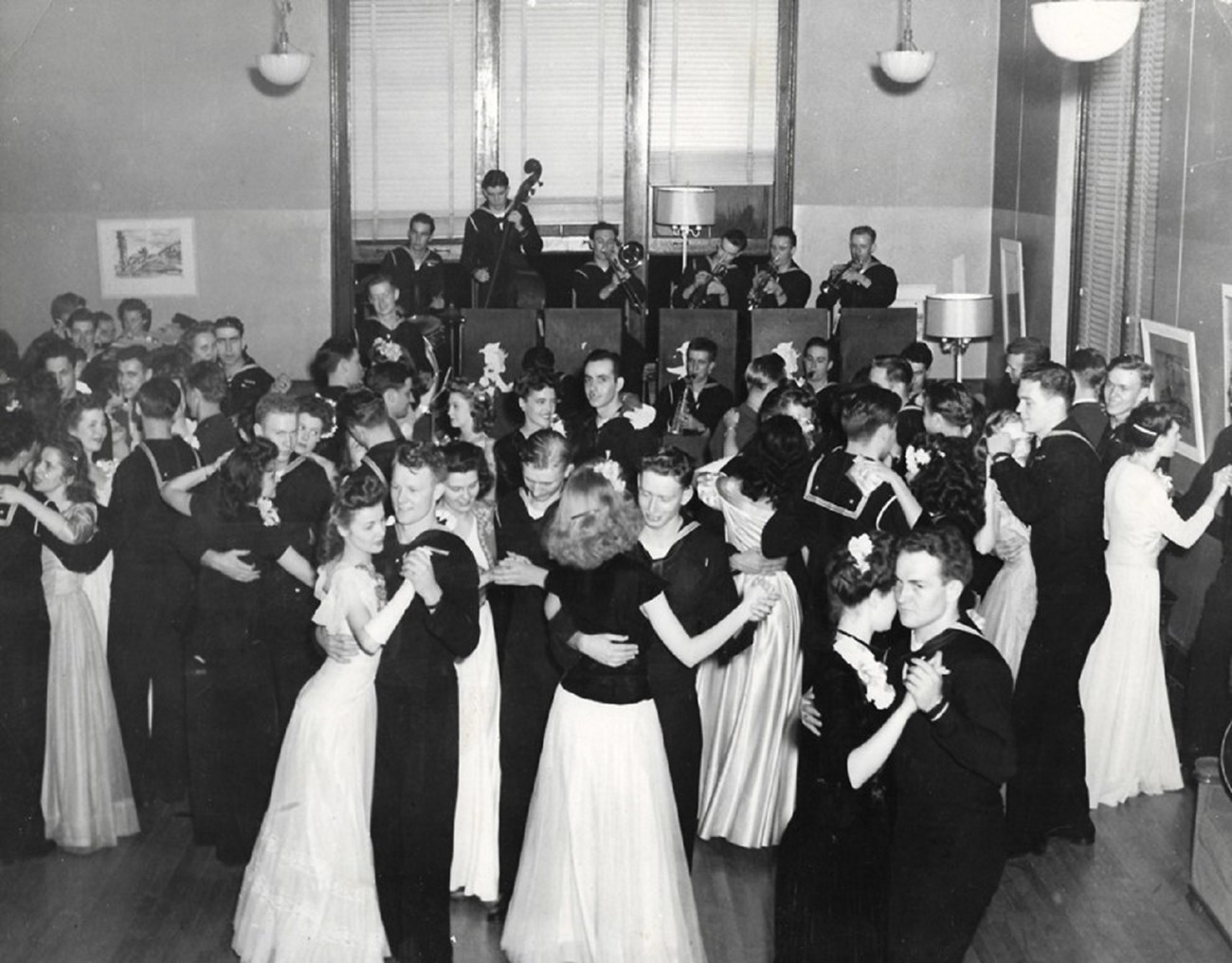 black and white photo of men and women dancing at a formal dance