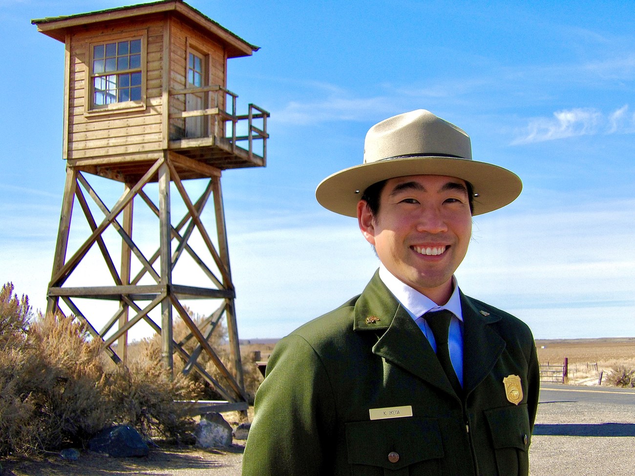 Kurt Ikeda in front of the guard tower at Minidoka National Historic State