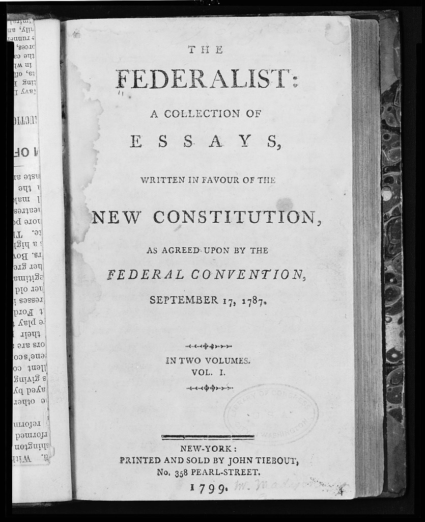 A printed cover page in a book reading "The Federalist: a collection of essays written in favour of the new Constitution, as agreed upon by the Federal Convention, September 17, 1787. In two volumes. Vol 1. New-York: Printed and sold by John Tiebout 1799