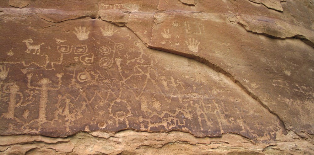 Petroglyphs carved on a rock face Petroglyphs carved on a rock face