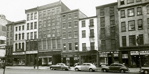 Market Street Houses 1950 Black and white photo of brick buildings with a carriageway.