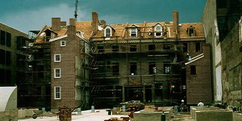 Market Street Houses, 1974 Red brick row houses surrouded by scaffolding and construction debris.