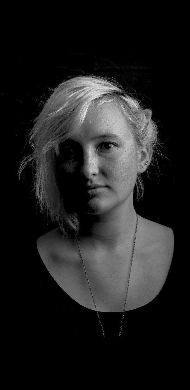 Portrait of a woman with light hair, earrings, and a necklace Portrait of a woman with light hair, earrings, and a necklace