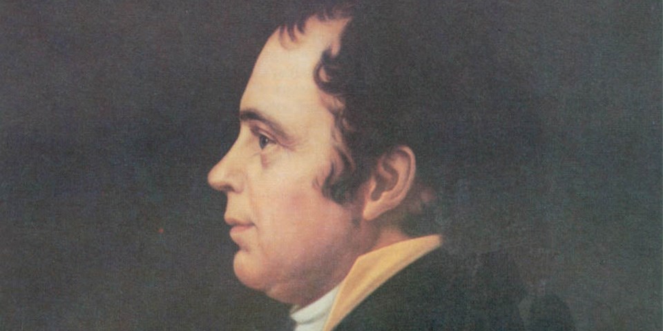 Close-up portrait of James McHenry facing left wearing black coat.