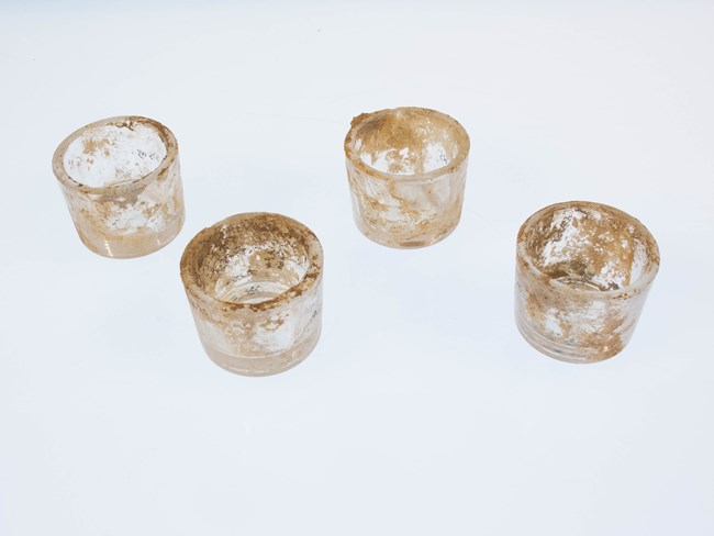 glass inserts four small, dirty glass inserts.