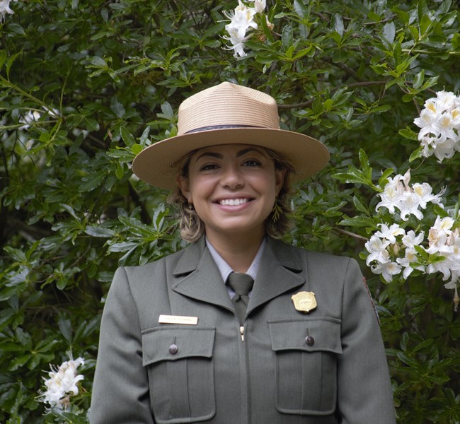 a woman in National Park Service uniform smiles at the camera