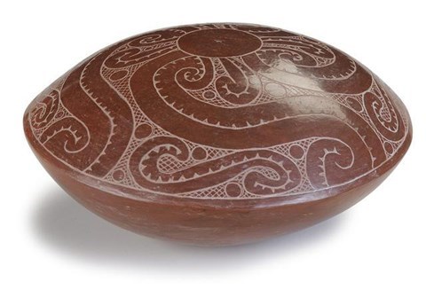 A rounded bowl, convex shaped red pottery.