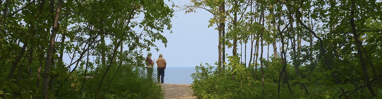Two people stand at an overlook