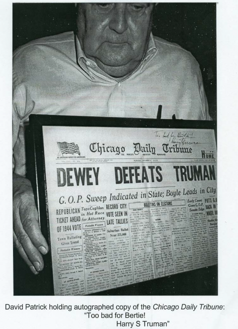 Father David C. Patrick holding newspaper