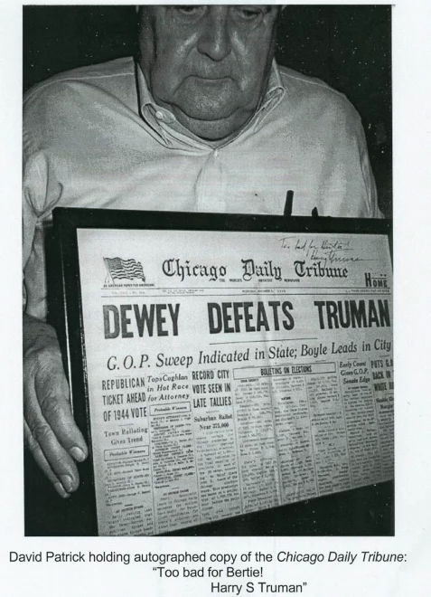 Father David Patrick Father David C. Patrick holding newspaper