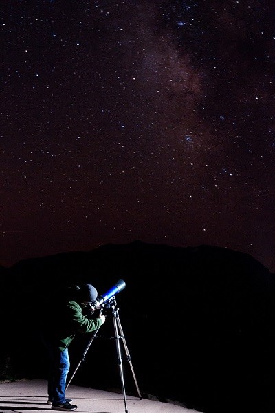 man stargazing during starry night