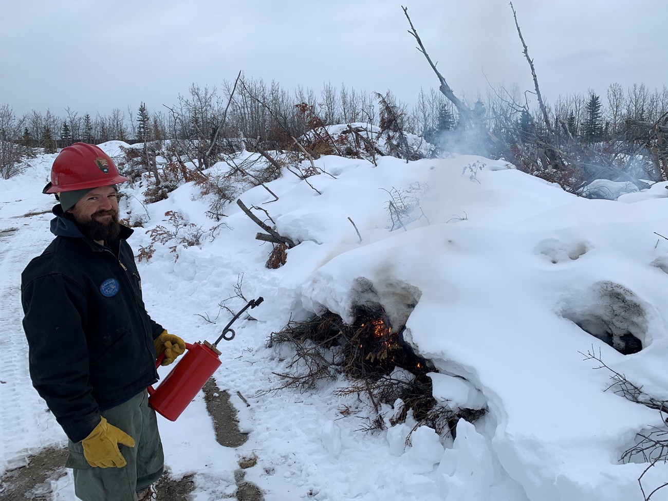 Winter or spring is the time to burn piles in Alaska.  NPS Alaska Eastern Area fire staff burned woody debris in April that was removed from a fuels treatment site at Wrangell-St. Elias National Park Headquarters and Visitor Center thinning project.