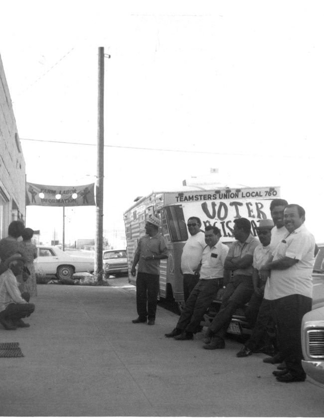 Quincy, voter reg drive A group of men stand in front of a truck with a Voter Registration drive