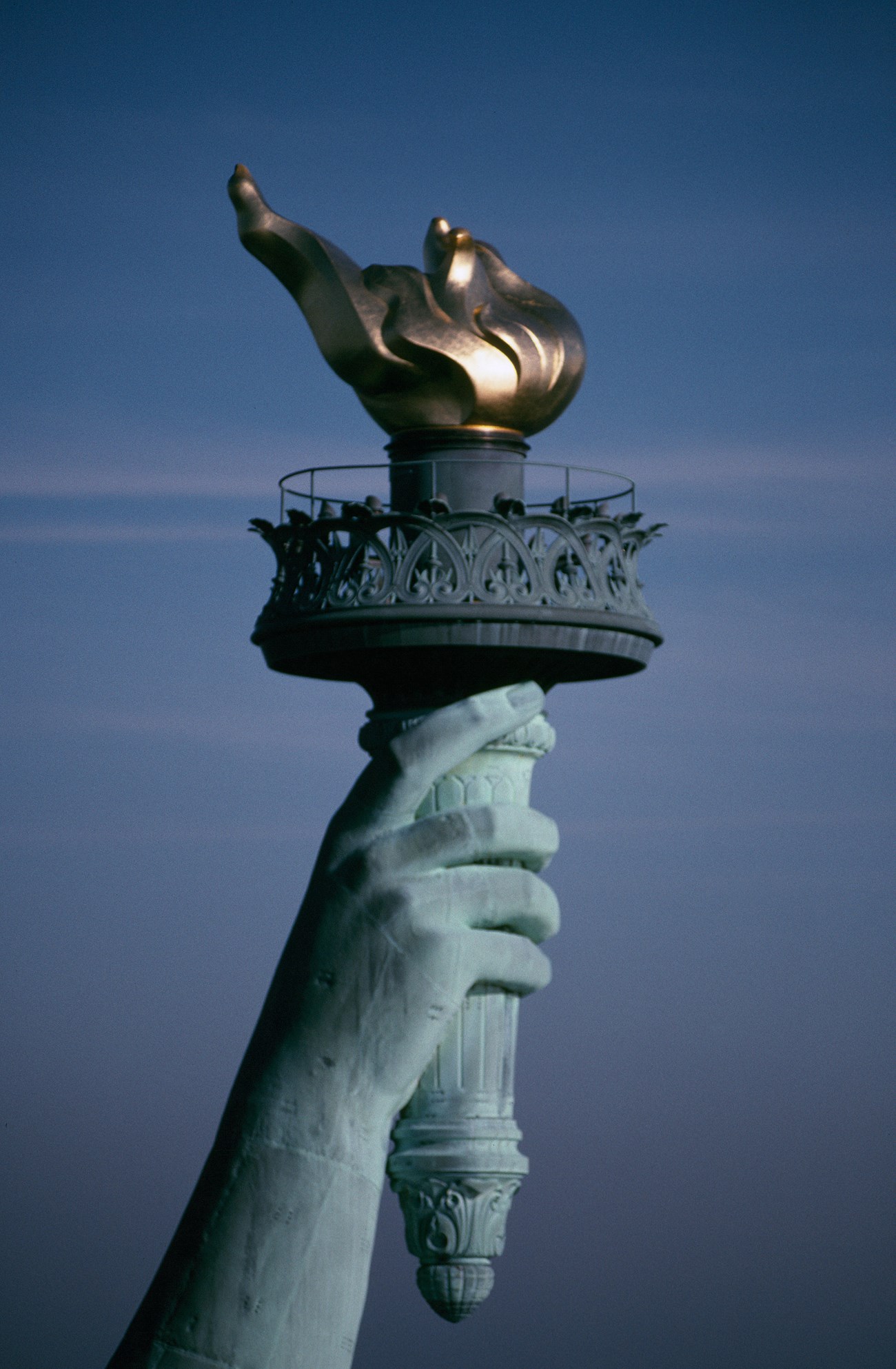 Close-up of the golden torch of the Statue of Liberty held in the statue's outstretched hand