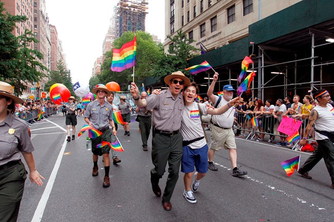 Park rangers and others march in a gay pride parade