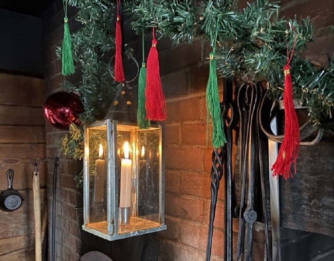 Green and red tassels attached to a string to make a garland.