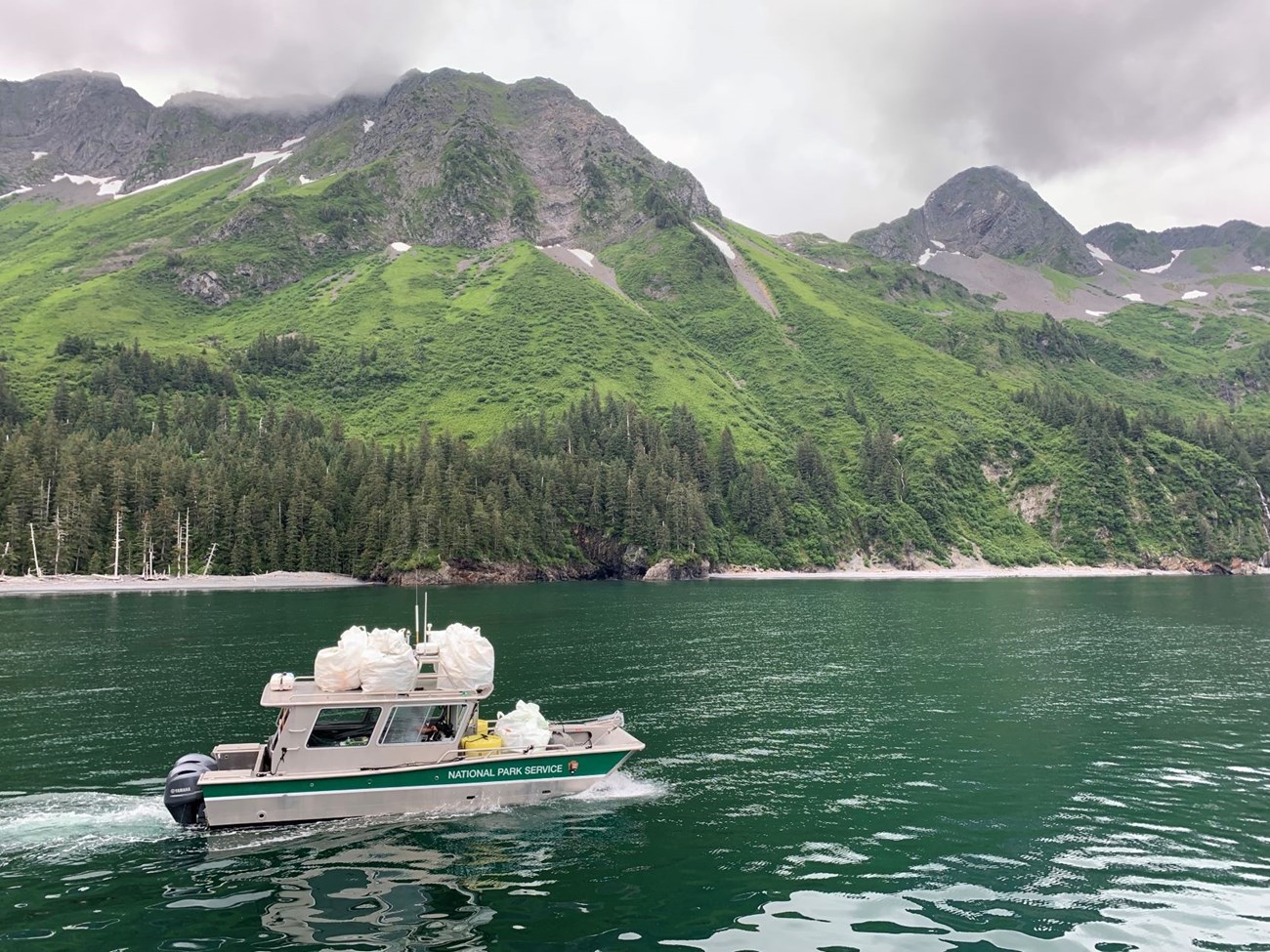 A boat is loaded with bags of marine debris and headed for Seward for disposal.