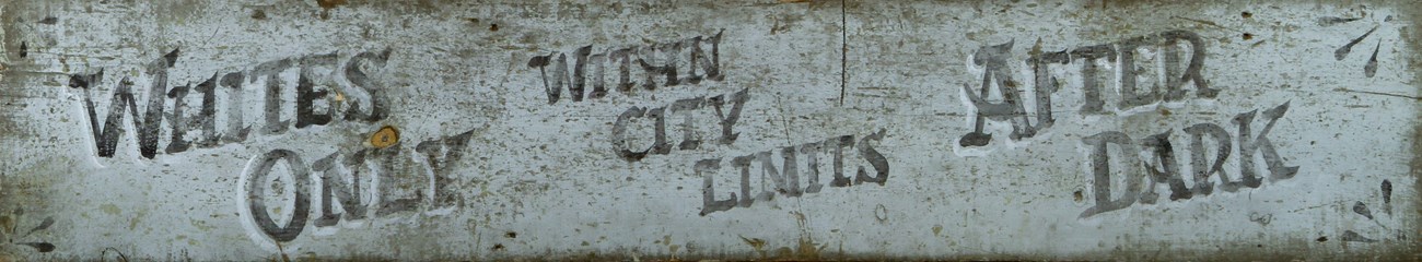 A sundown town sign from 1900 in Macon, Georgia that reads "Whites only within city limits after dark."