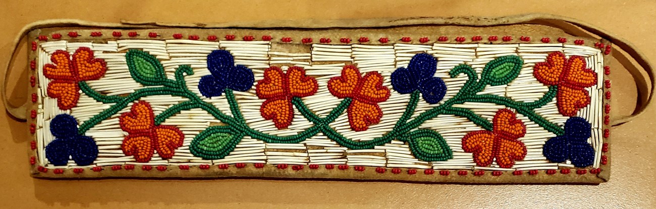 Multi-colored traditional Anishinaabe sash with beads and porcupine quills.