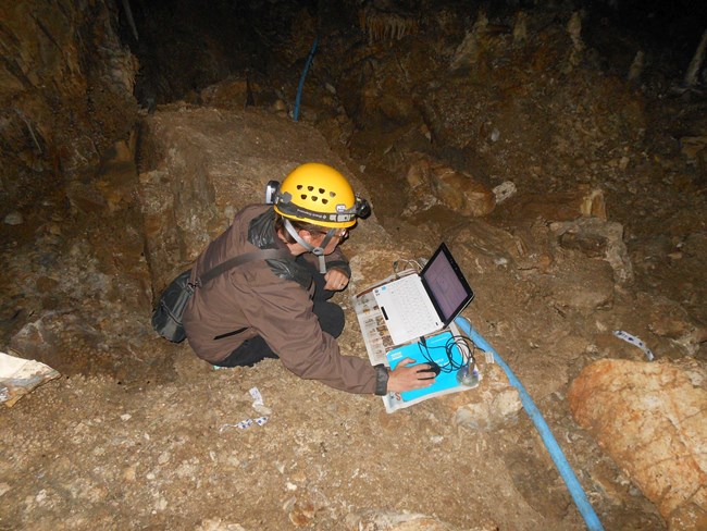 Staff member downloading dataloggers in Lehman Caves.