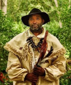 a black man dressed in 1800's period clothes