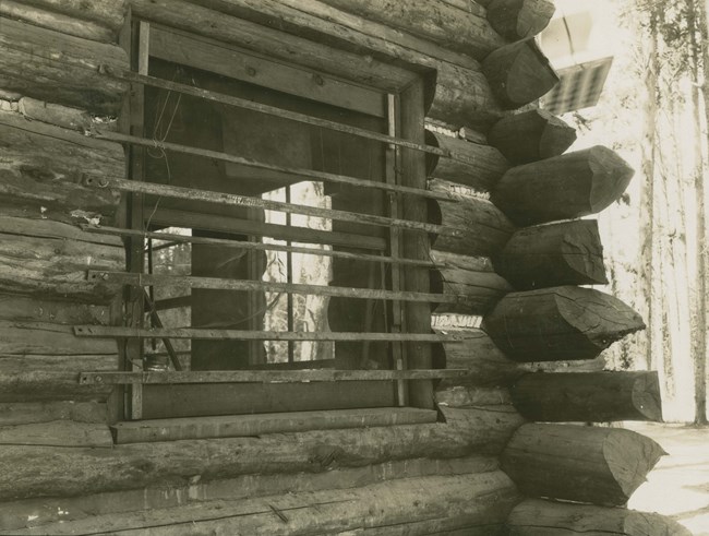 Bear proofing attempt Metal bars over a window in a log cabin