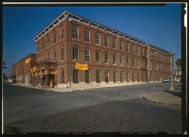 Ybor City cigar factory Three-story brick building with yellow banner