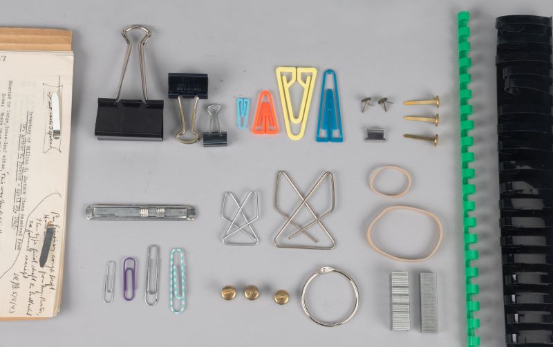 Different kinds of paper clips, binder clips and other fasteners found in archives.