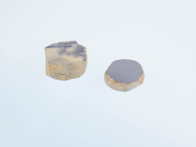 two circular pieces of blue ceramic on a white background