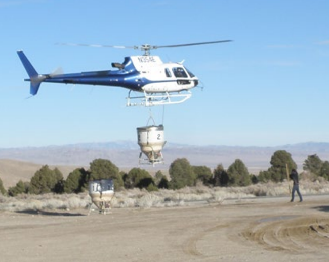 helicopter with hopper Helicopter returning with empty hopper after  seeding.