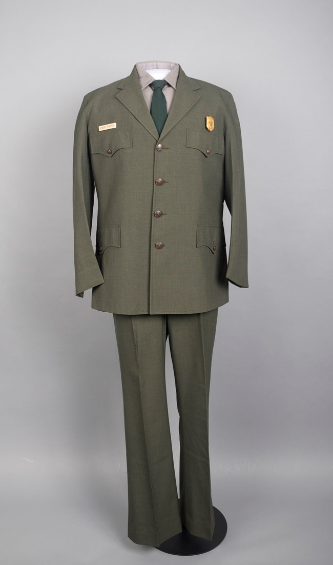NPS uniform pants, shirt, tie, coat, badge on a mannequin