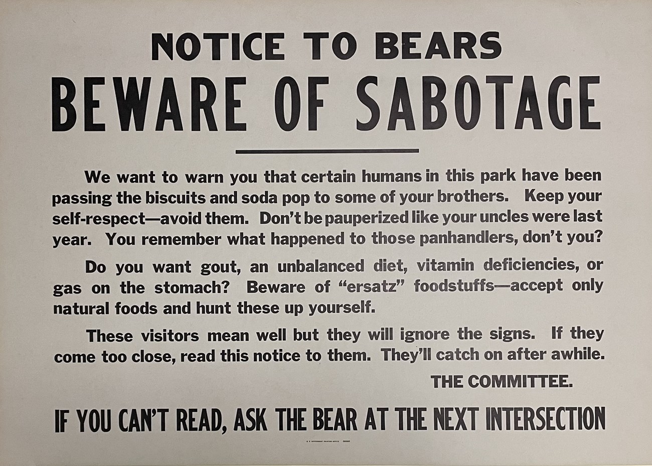 Beware of sabotage poster Poster with black letters warning bears that people are trying to sabotage them by feeding them