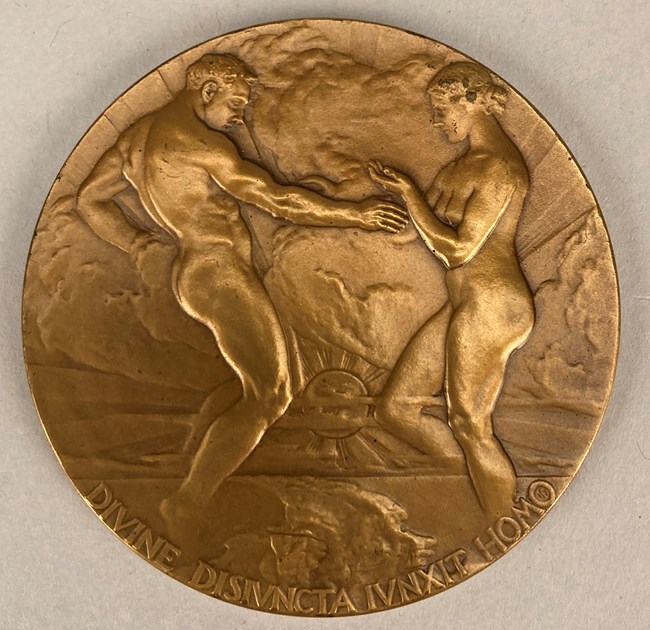 Round bronze metal with nude man and woman