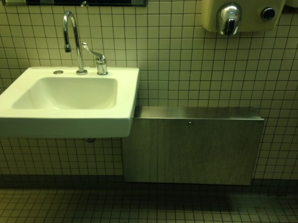a sink on the left and hand dryer on the right